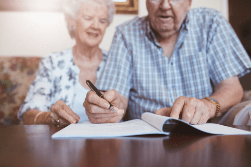 elderly couple completing estate planning